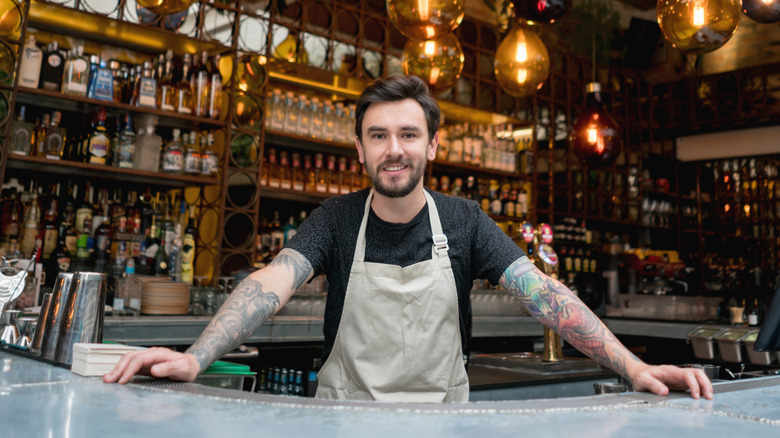 Bartender smiling behind bar