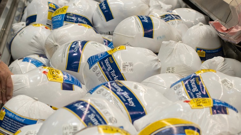 Packaged turkeys stacked in grocery store display