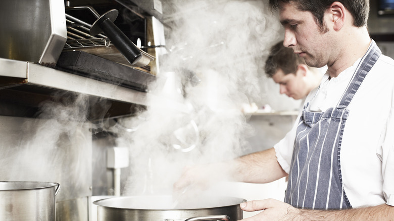 A cook steaming food