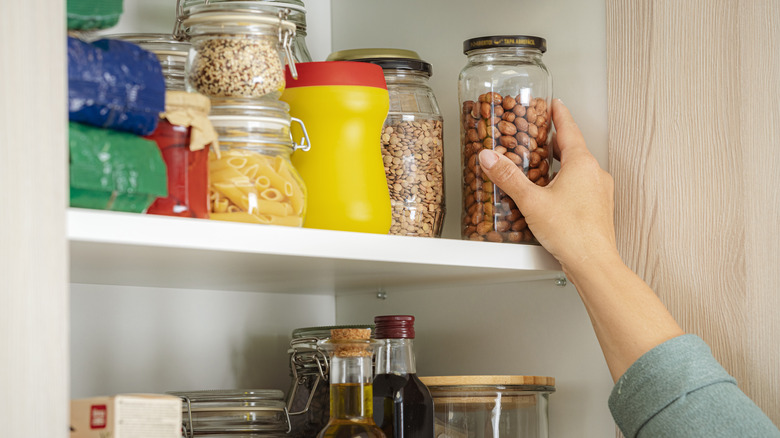 woman reaching into a pantry