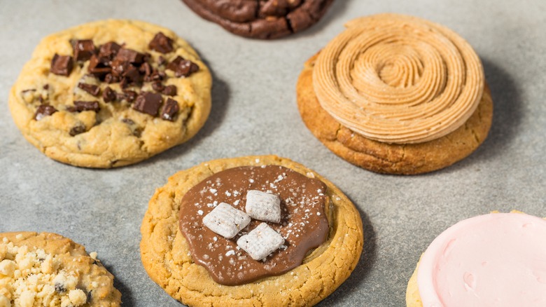 Crumbl cookies on a parchment paper-lined tray