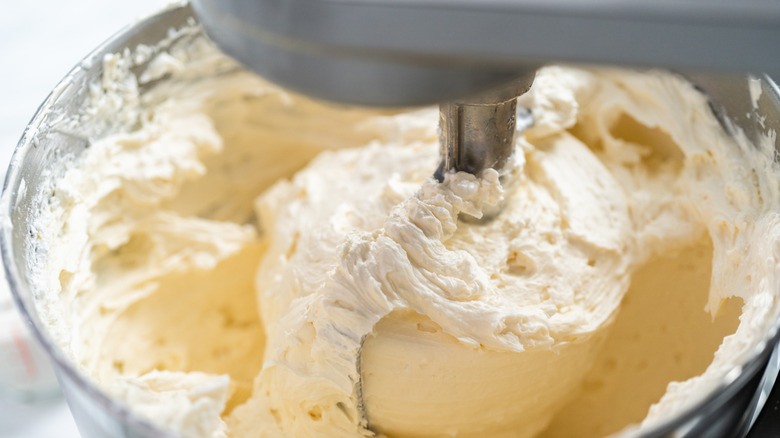 beating buttercream in mixing bowl