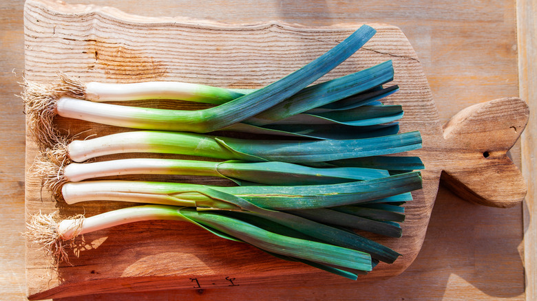 whole leeks on cutting board