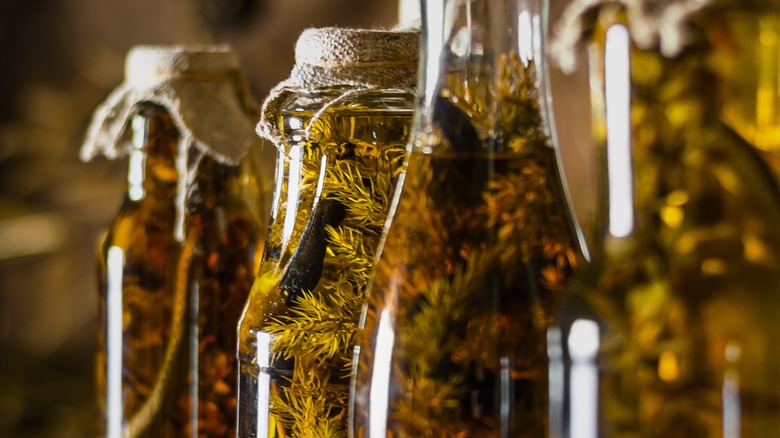 herbs infusing in glass bottles