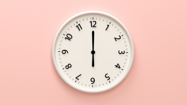 white clock on pink wall