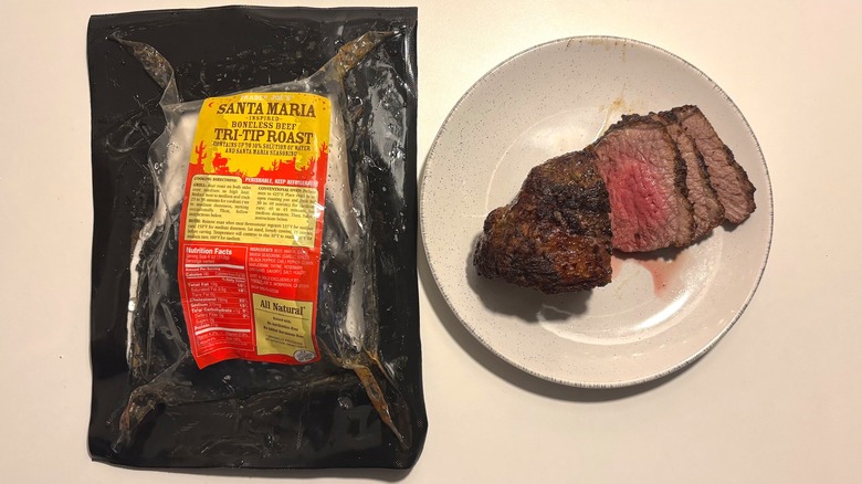 Trader Joe's Santa Maria Tri-Tip Roast package next to roast on plate on white table