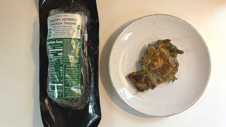 Trader Joe's Savory Herbed Chicken Thighs package next to plate of chicken thigh on table