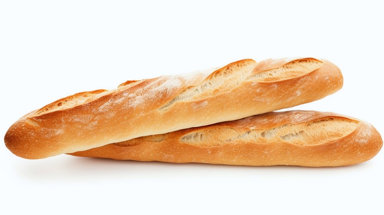 Two overlapping baguettes on white background 