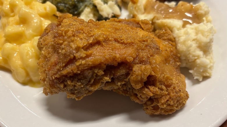 Piece of Golden Corral fried chicken on white plate