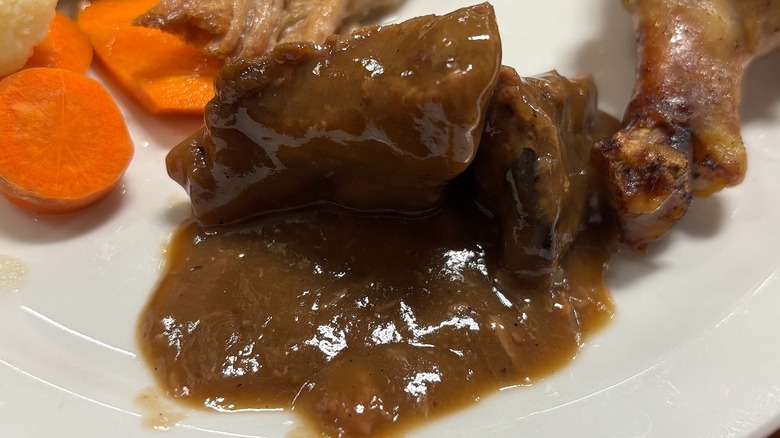 Golden Corral pork with gravy on white plate