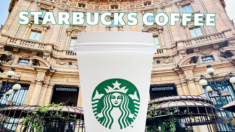 White starbucks cup in front of starbucks coffee storefront in italy