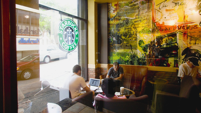 People working on their laptops at Starbucks coffee shop