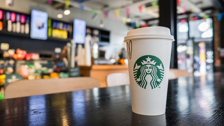 Cup of Starbucks coffee on a counter inside coffee shop