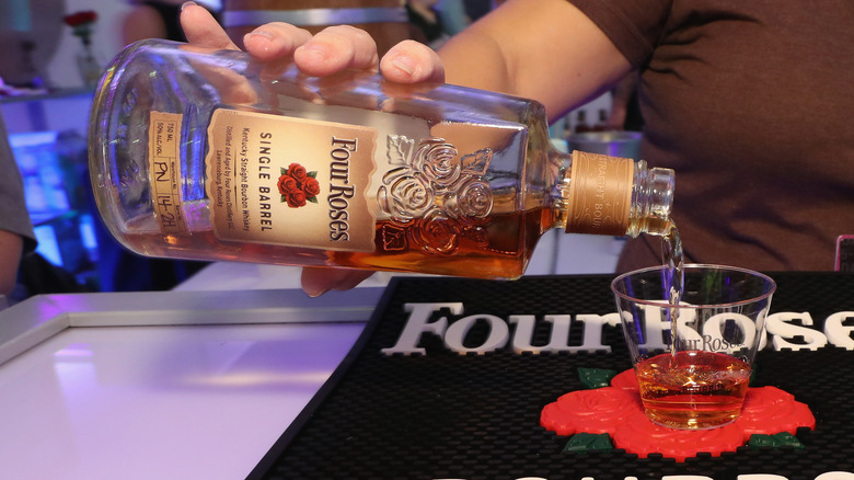 Person pouring Four Roses bourbon