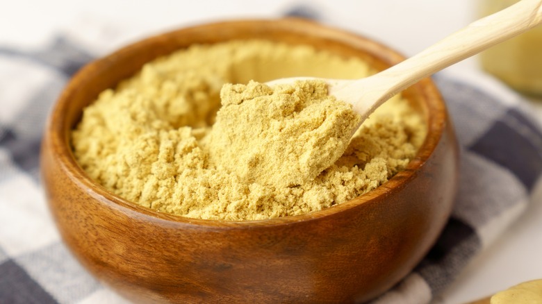 Mustard powder in wooden bowl