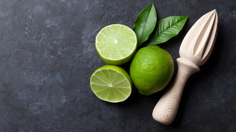 Limes and a juicer