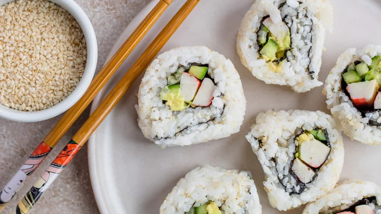 Top-down view of plated California roll sushi and chopsticks