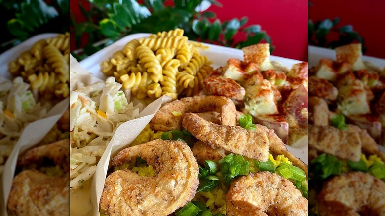 Takeout box with vegan fried shrimp, coleslaw, and macaroni