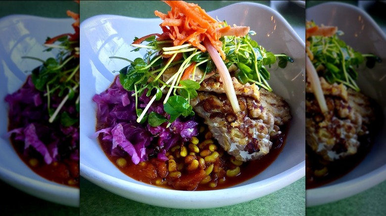 Tempeh with peas, carrots, sauerkraut, pea shoots, and pickle salad