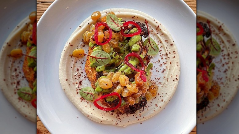 Cauliflower steak garnished with fresh produce