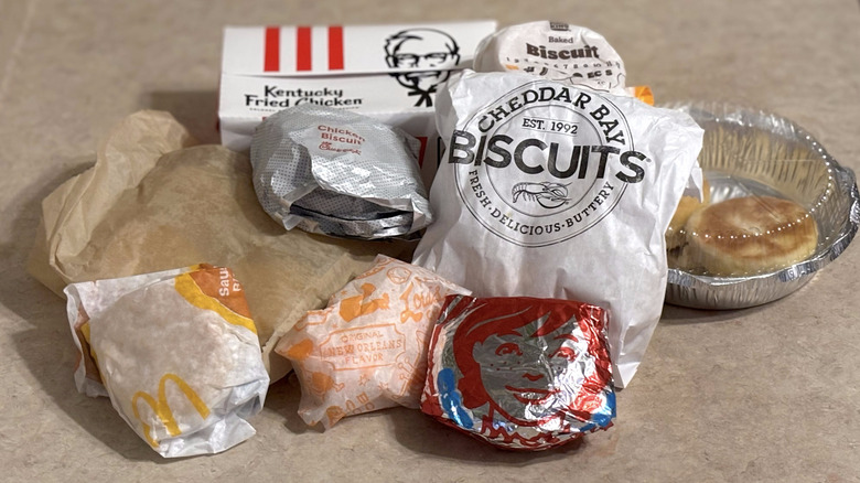 Assorted restaurant chain biscuits in packaging on a neutral counter top