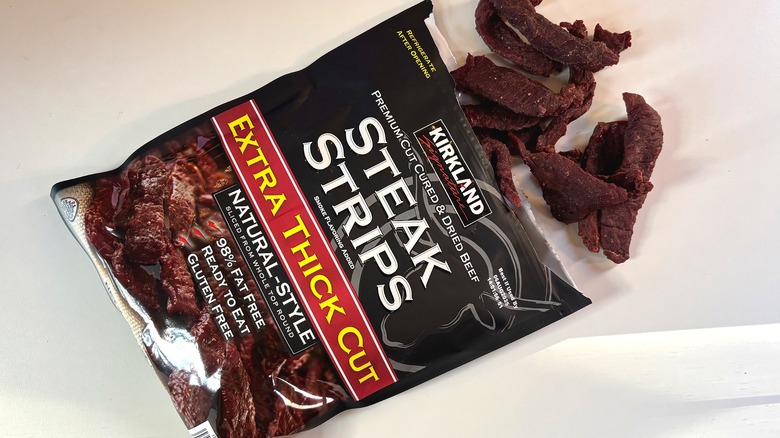 Kirkland Extra Thick Steak Strips spilling out of bag onto white table