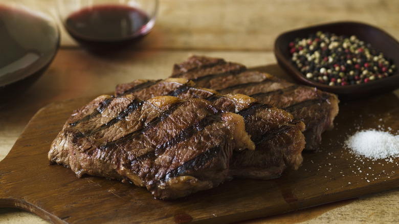 Ribeye steaks on cutting board