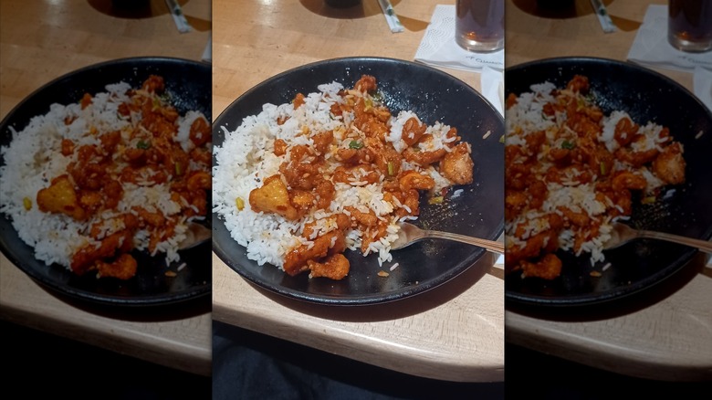 Spicy chicken and white rice on black plate at P.F. Chang's