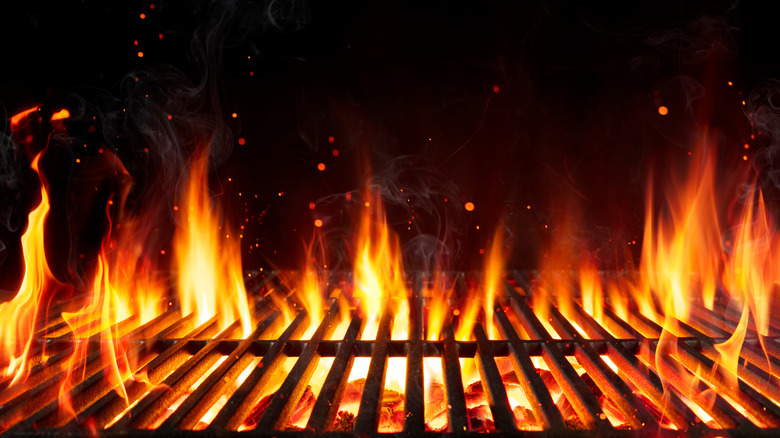 Flames rising through grill grates