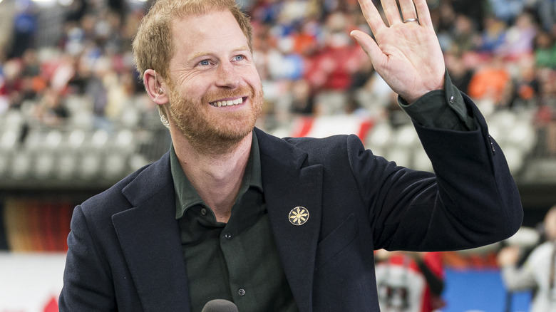 Prince Harry waving at crowd during an event