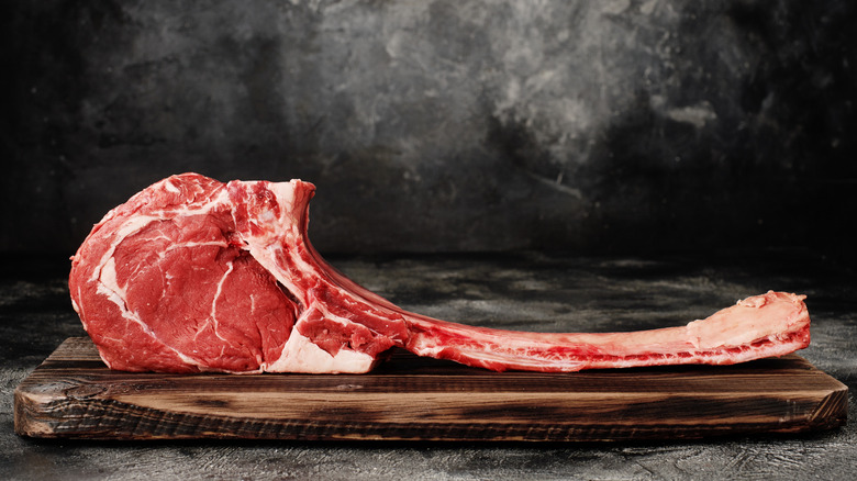 raw tomahawk on cutting board