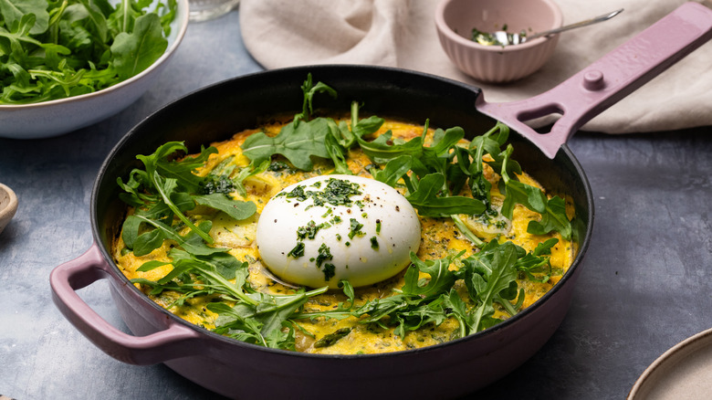 frittata in pan with burrata and arugula