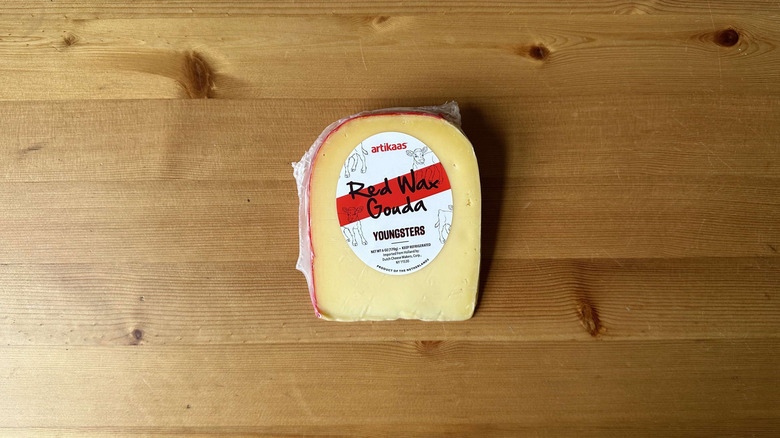 Artikaas Youngsters Red Wax Gouda cheese on wooden background