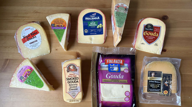 Variety of gouda cheeses on wooden table