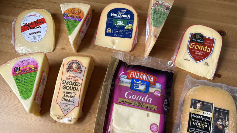 Variety of gouda cheese on wooden table