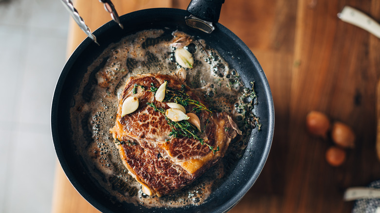 searing steak in a pan