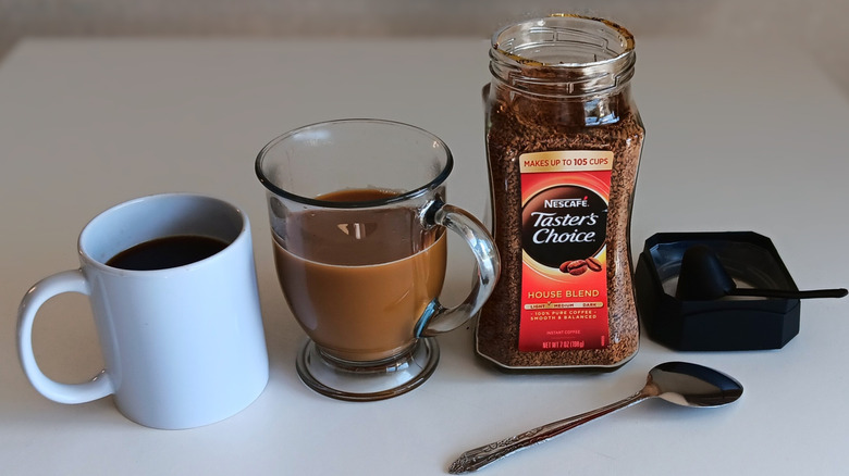 Nescafe Taster's Choice instant coffee jar and mugs of coffee