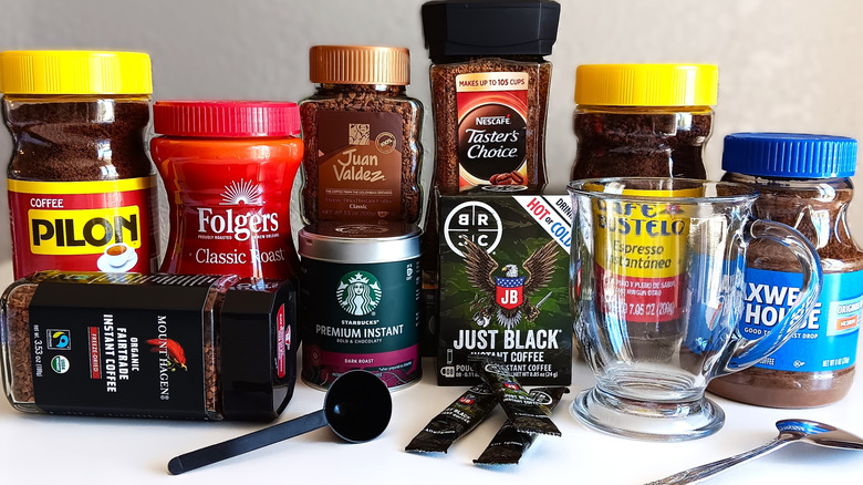 variety of instant coffee brands and an empty glass mug