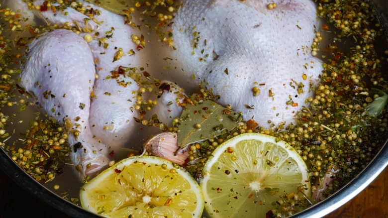 soaking the chicken in a brine solution using lemon, herbs and aromatic