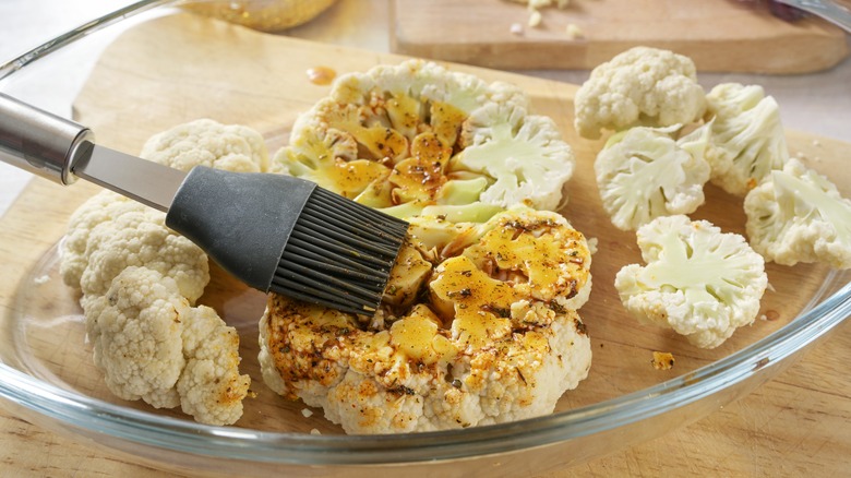 brushing cauliflower with oil