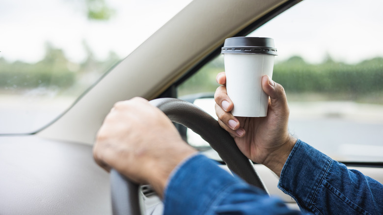 holding takeout cup while driving