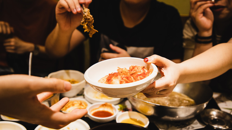 Hand sharing Korean food