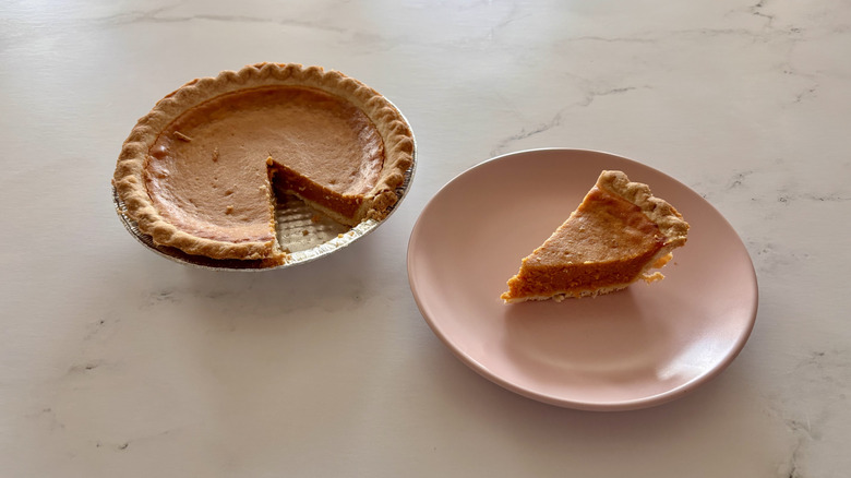 A pumpkin pie sitting on a table.