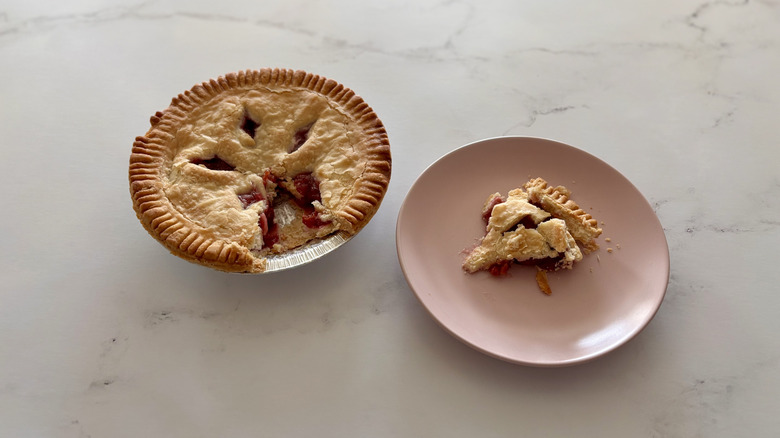 A cherry pie sitting on a counter.