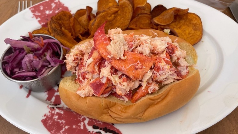 lobster roll with potato chips and coleslaw