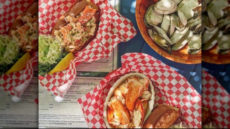 table with lobster rolls and clams