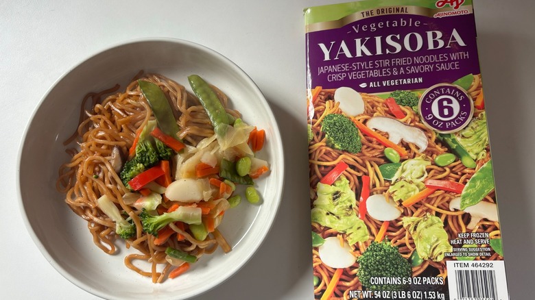 plate of ajinomoto vegetable yakisoba next to box on table