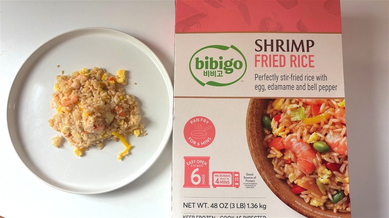 plate of bibigo shrimp fried rice next to box on table