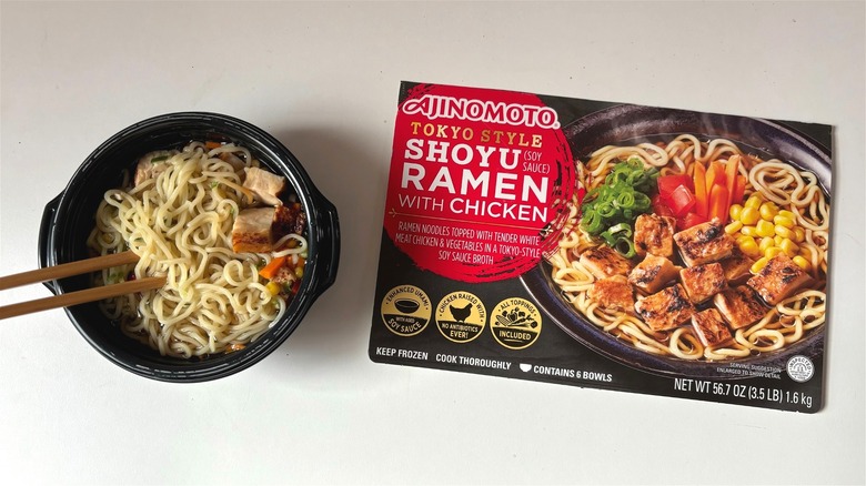 ajinomoto shoyu ramen with chicken bowl next to box on table