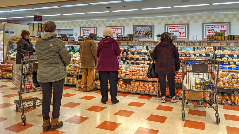 People waiting at deli counter